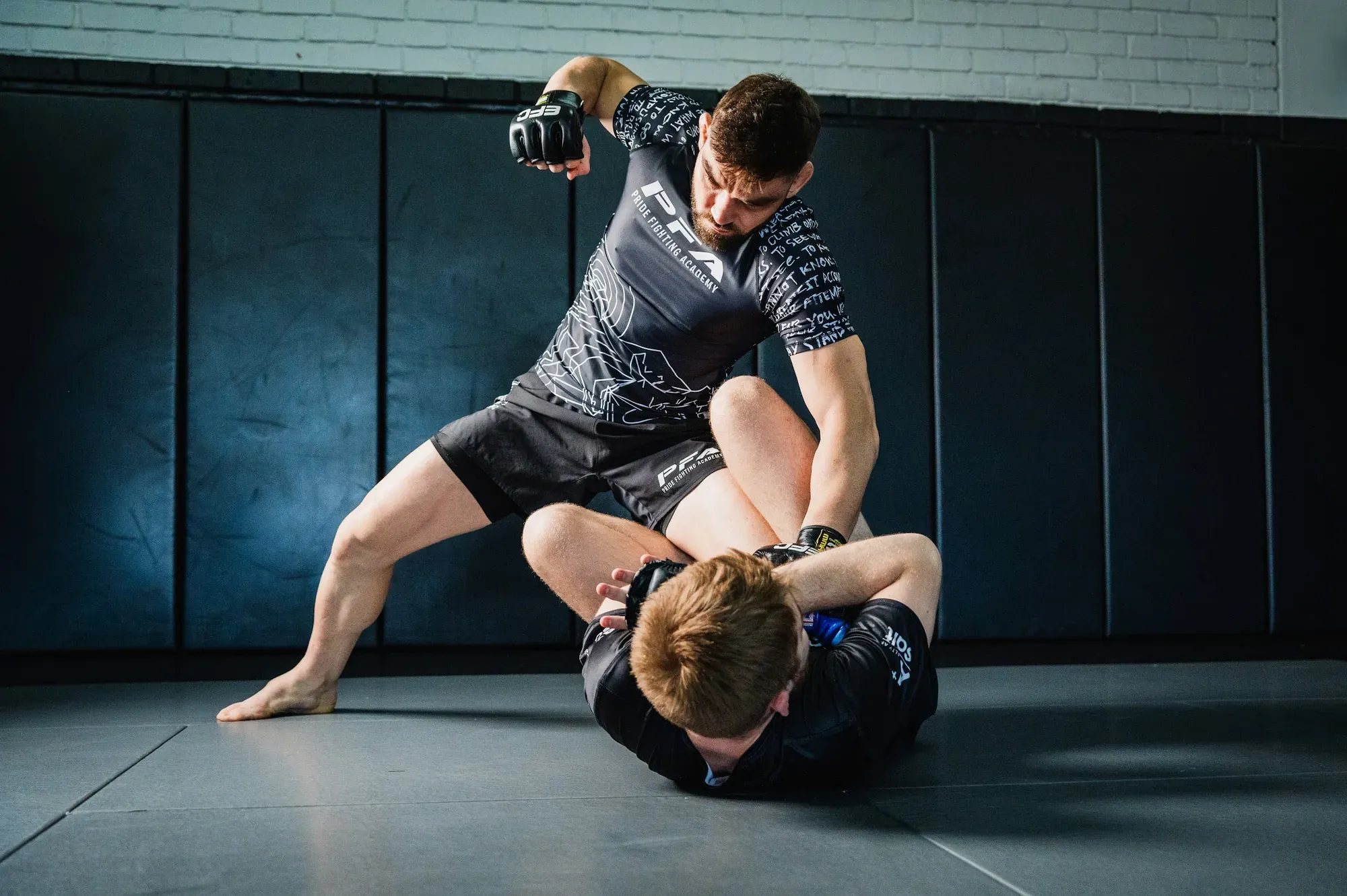 Fighter passing guard during an MMA class at PFA