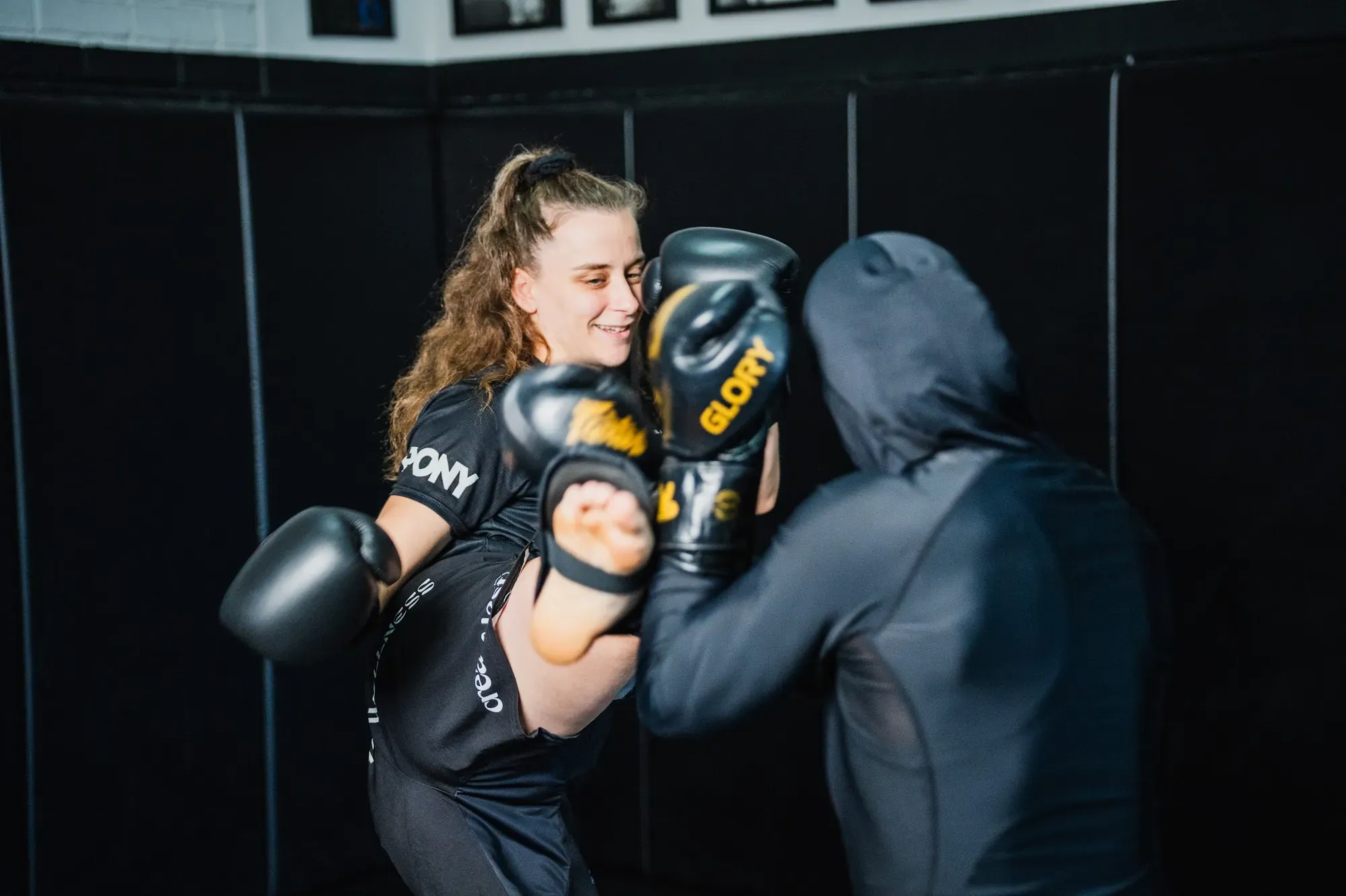 Woman throwing a straight punch in kickboxing class